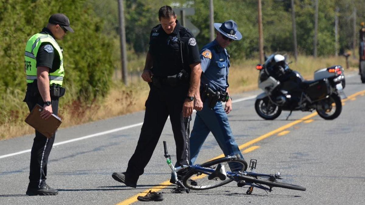 
Investigators examine a bicycle struck by an SUV on East Smith Road near Sand Road Tuesday afternoon, Aug. 18. The 69-year-old bicyclist, who was wearing a helmet, suffered serious injuries.
