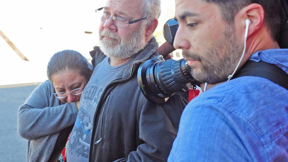 Arcan Cetin’s stepfather David Marshall is swarmed by the media outside the Skagit County District Court on Monday, Sept. 26, 2016 moments after Cetin appeared in court under a magistrate’s warrant which will give Skagit County prosecutors 30 days to file official charges against him in the Cascade Mall shooting where five people were murdered on Friday, Sept. 22, in Burlington.