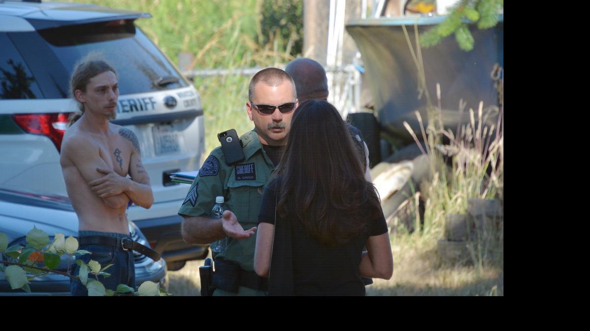 
Whatcom County Sheriff’s Detective Sgt. Sean Crisp talks to support officer Kendra Cristelli while investigating a shooting in the 6300 block of Siper Road on Friday, June 26. 

