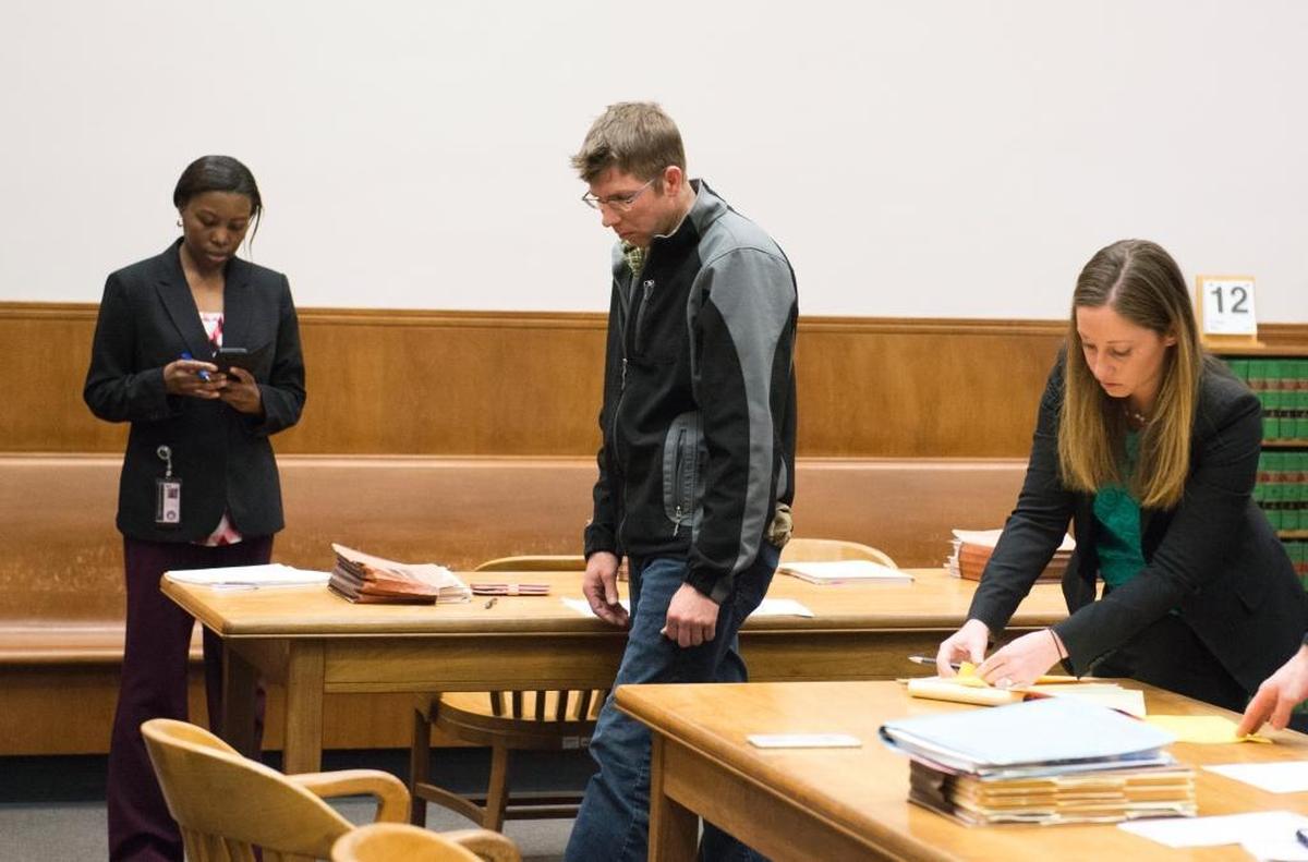 Seth Snook, center, heads toward the door after his first appearance in Whatcom County Superior Court on Friday, May 12, in Bellingham. Snook is charged with five counts of first-degree animal cruelty after investigators found more than 20 emaciated cows and pigs on his farm near Ferndale.