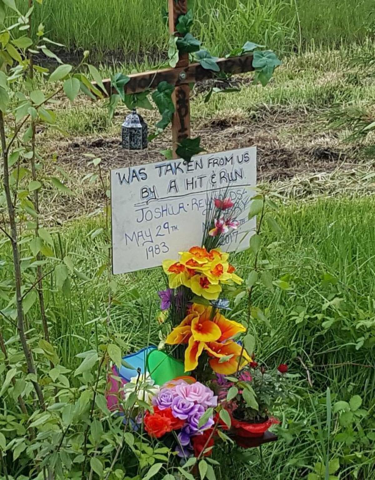 A memorial cross marks the spot, Tuesday, May 16, 2017, where a passerby found the body of Joshua Karl Reynolds, 33, Monday morning in a ditch on the north side of the 3900 block of Birch Bay-Lynden Road.