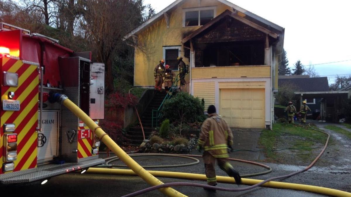 Firefighters work at home at 314 Whatcom Street on Saturday, Dec. 5, after a couch fire on the porch spread.
