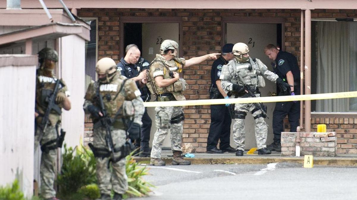 
Local law enforcement officers respond to a shooting at the Villa Inn on Samish Way, Monday, Aug. 26, 2013, in Bellingham. Alexander Warren Johnson, who shot at police and was then hit by return fire, has been sentenced to more than 11 years in prison. 
