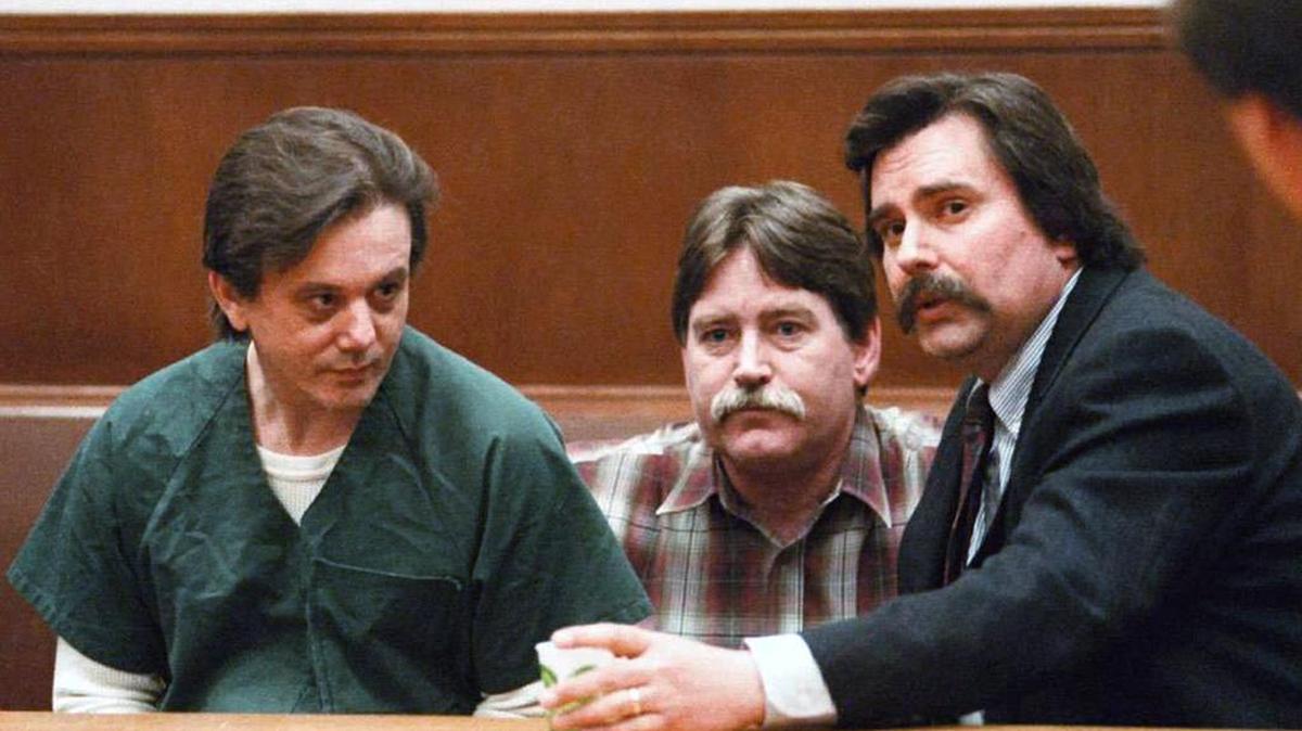FILE - In this March 12, 1996, file photo, Clark Richard Elmore, left, talks with his lawyer, Whatcom County Public Defender Jon Komorowski, right, and Public Defender’s investigator Michael Sparks, center, before Elmore was sentenced to death for the murder of his girlfriend’s daughter, Christy Lynn Ohnstad, 14, in Bellingham, Wash.
