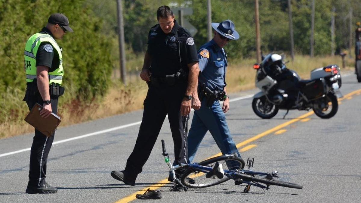 
Investigators examine a bicycle struck by an SUV on East Smith Road near Sand Road Tuesday afternoon, Aug. 18. Sylvia I. Woodbury, the 69-year-old cyclist who was wearing a helmet, suffered serious injuries.
