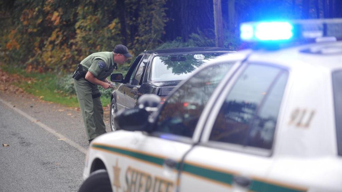 A Whatcom County Sheriff’s deputy talks to a driver pulled over on Loomis Trail Road in 2010. Washington State Patrol troopers will be cracking down this week on people who don’t move over for stopped emergency vehicles with lights flashing