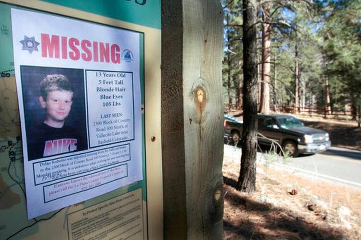 In this Nov. 26, 2012 file photo, a missing poster of 13-year-old Dylan Redwine hangs on a trail head sign next to Vallecito Reservoir in Vallecito, Colo.