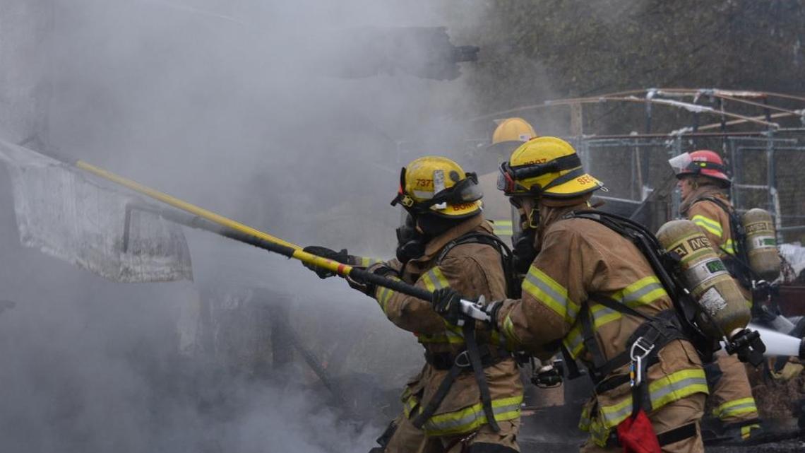 Firefighters pull down the metal walls of a barn that caught fire Monday, Nov. 23, 2015, at 4593 Bay Road near Birch Bay. No one was hurt.