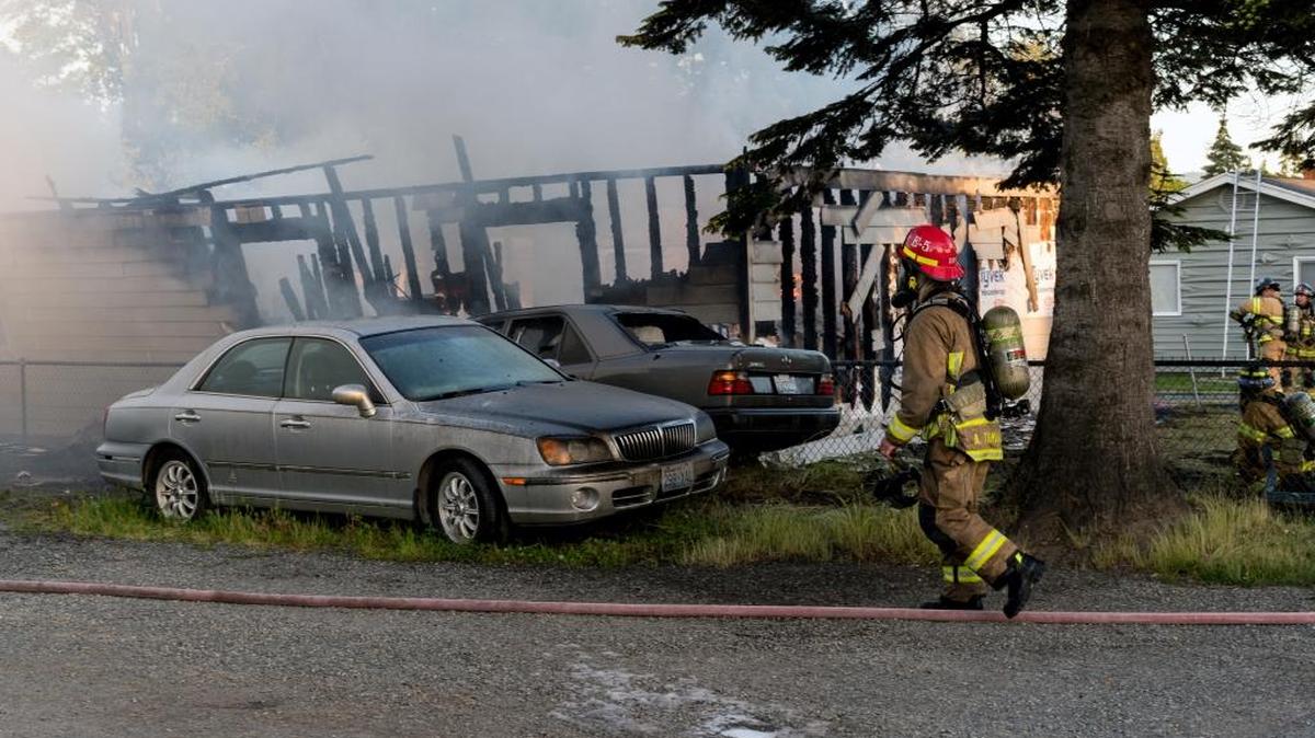 Firefighters battle a fire in the 3400 block of Bennett Drive on Monday, June 6, 2016 in Bellingham, Wash.