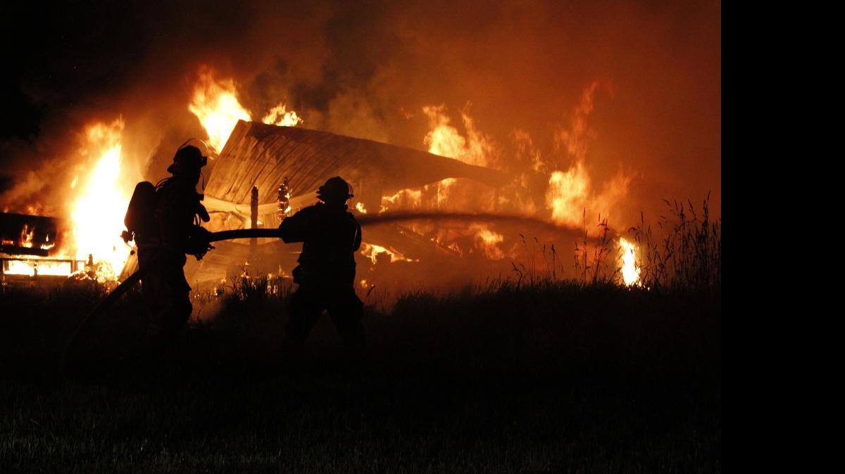 
Firefighters work at the fire that destroyed a machine shop early Sunday morning near Everson.
