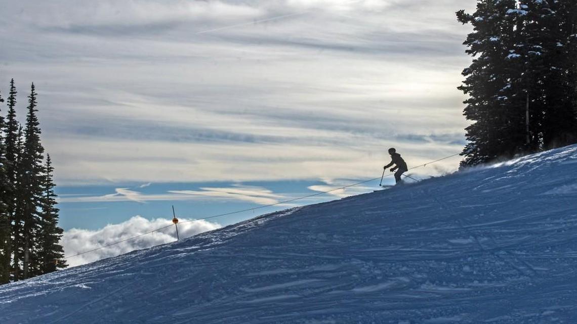A skier cruises down Upper Ferk’s Run at Crystal Mountain on Dec.1, 2014. The ski area opened with minimal snow, allowing skiing on Green Valley Express only, with the gondola available for access to the mountaintop and views with great visibility.