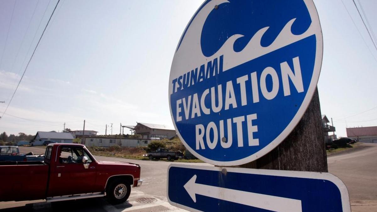 A sign directs traffic to an evacuation route in the event of a tsunami on the Quileute Indian reservation in La Push.