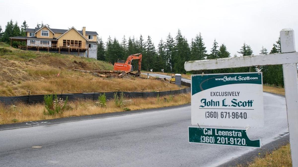 A partially constructed house sits on a hillside along Samish Crest Drive on Thursday, July 7, in Bellingham. Local real estate agents say the influx of new residents is partly a result of high home prices in the Seattle and Vancouver, B.C. markets.