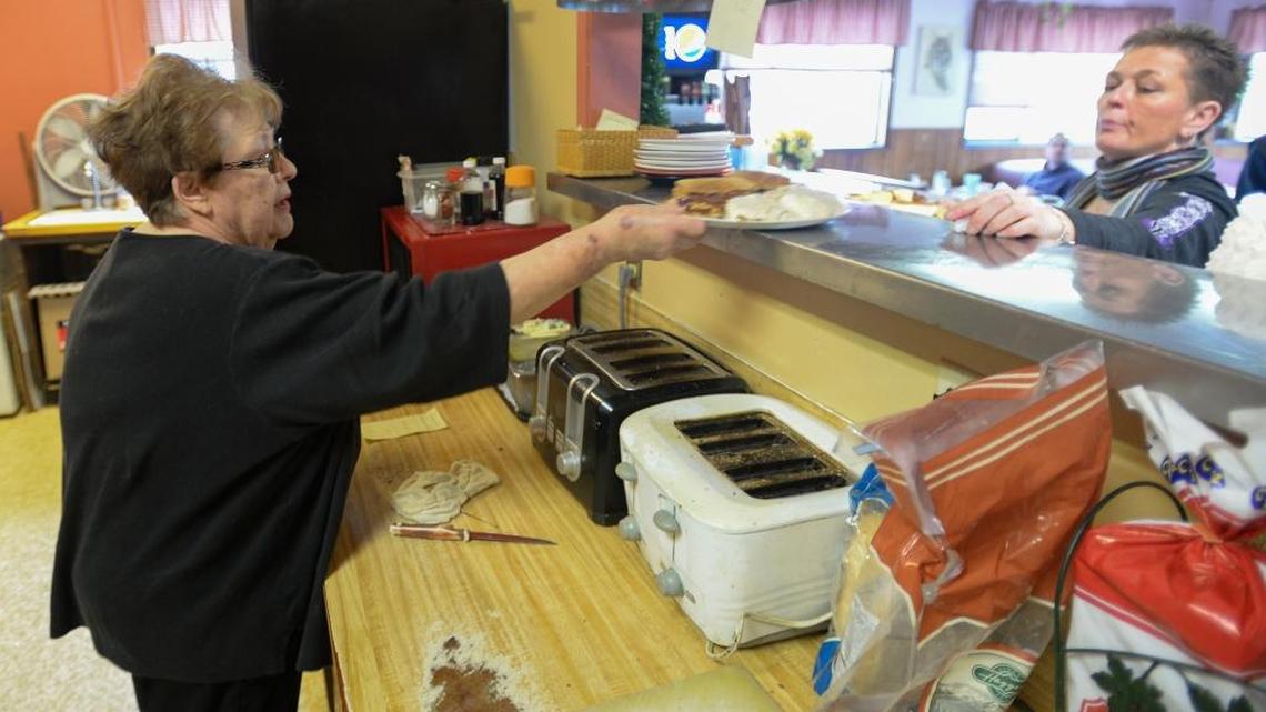 Barbara Bruland, left, hands a breakfast order to her daughter, Vickie Henderson, at The Hungry Bear Restaurant in Deming, Wednesday, Jan. 27, 2016. The family-run restaurant will close Feb. 29.