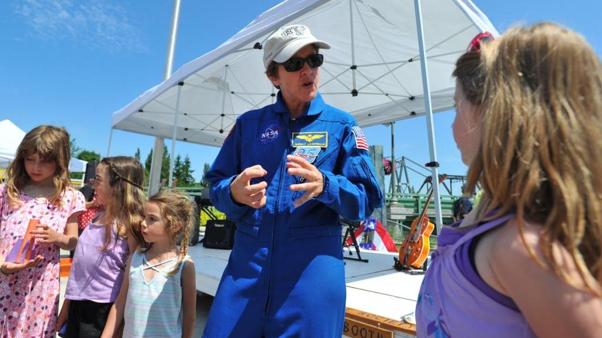 “We go into space to learn,” retired astronaut Wendy Lawrence, who flew in the space shuttle, tells children at the Ferndale Public Market during a presentation in July 2011.