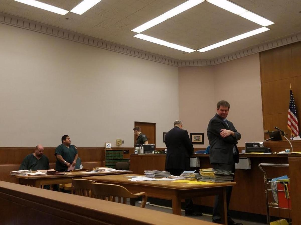 Gilberto Chino Acatitlan, 28, of Bow stands (far left) Friday wearing a green jail-issued uniform to be arraigned in Whatcom County Superior Court. He is one of 20 men arrested in an undercover Washington State Patrol sting operation that targeted internet predators attempting to solicit sexual contact with minors.
