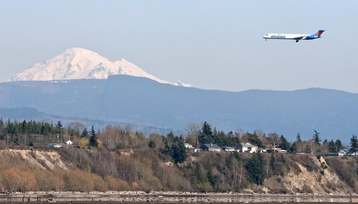 An Allegiant Air flight flies into the Bellingham International Airport, March 30, 2013. Allegiant will start offering nonstop flights from Bellingham to Denver in May.