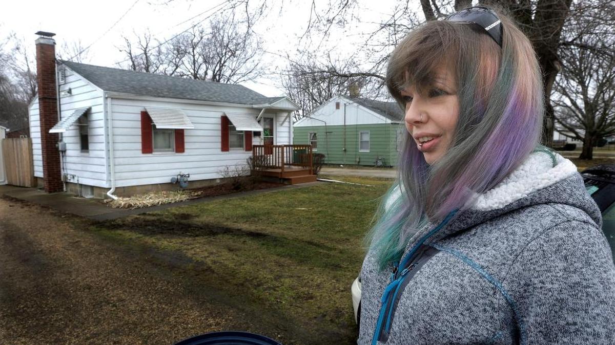 Whitney Zielke, 32, poses for a photo March 9, 2016, outside her mother’s home on a street where testing revealed high amounts of lead, in Galesburg, Ill. Zielke said her mother “freaked out” after receiving that notice but that she didn’t know what to think.