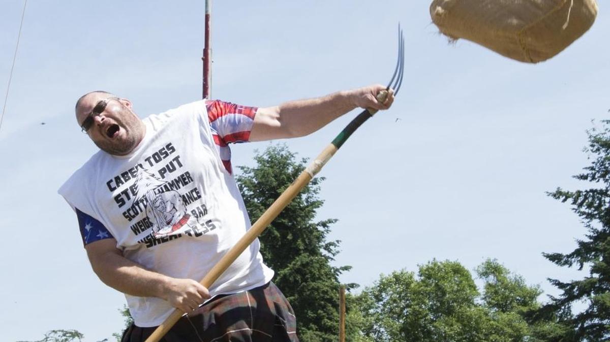 Tacoma resident Cory Frazier competes in the sheaf toss at the Bellingham Scottish Highland Games on June 6, 2016, at Hovander Homestead Park in Ferndale. Sheaf tossing is an event where competitors must hurl a 20 pound straw-stuffed burlap sack as high as they can over their heads. Frazier took first place in the event. This would have been the 57th year for the games, but the event has been canceled.