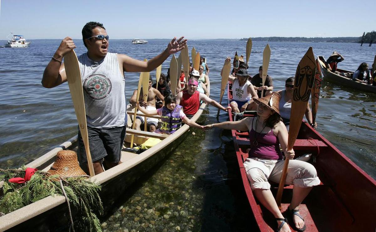 Members of the Samish tribe asks permission to come ashore during the 2007 Paddle to Lummi tribal canoe journey. This year, paddlers from Northwest tribes are expected to arrive in Whatcom County Wednesday, July 24. The Paddle to Lummi celebration will continue through Sunday, July 28, at the Lummi Nation Stommish Grounds.