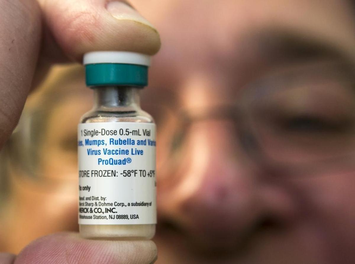 FILE - In this Thursday, Jan. 29, 2015 file photo, a pediatrician holds a dose of the measles-mumps-rubella (MMR) vaccine at his practice in Northridge, Calif.