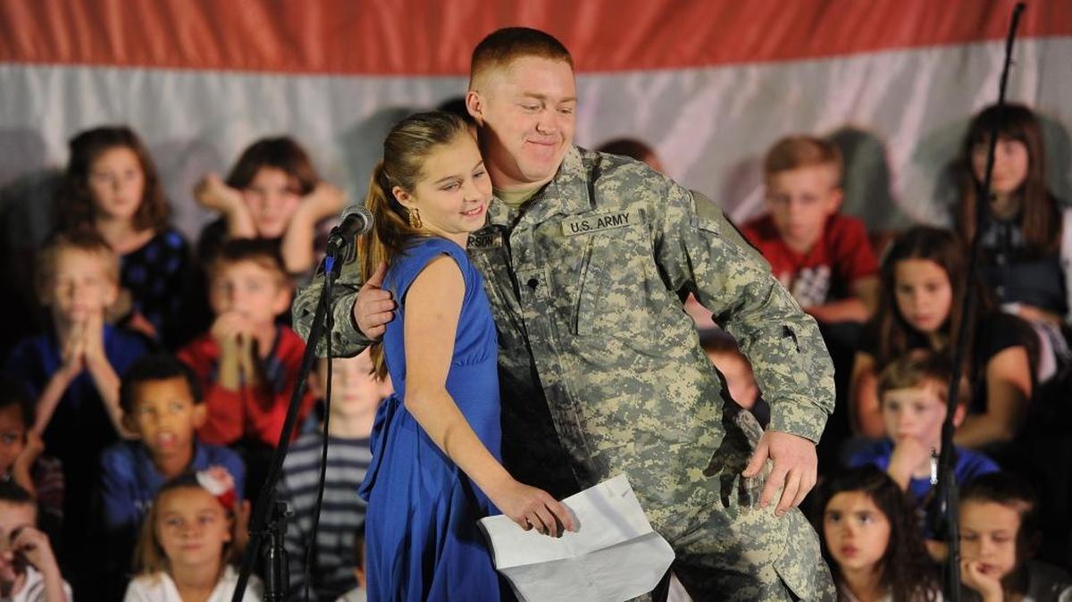 
Abbee Winton, then 12, gets a hug from cousin U.S. Army Specialist Leslie Anderson after introducing him during the annual Veterans Day program at Bellingham Christian School on Nov. 7, 2014. The Bellingham Herald is again asking Whatcom families to send in service-related stories and photographs, to appear in the Herald to mark Veterans Day 2015.
