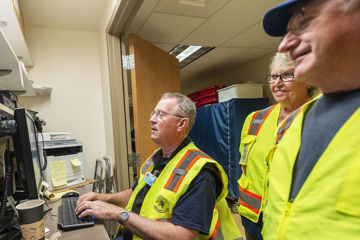 Amateur ham radio operators Don Boyer, of Bellingham, left, Ina B. Little, of Deming, and Dough Salkeld, of Acme, monitor radio calls during the Mount Baker Volcanic Eruption Exercise at St. Joseph hospital on Wednesday, Oct. 17.  The purpose of the drill is to help evaluate emergency response, medical needs, and communication requirements during natural or man-made disasters such as a volcanic eruption or earthquake.
