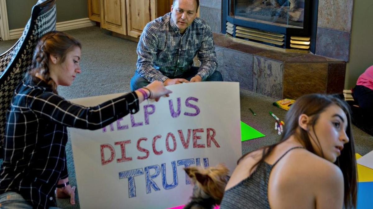Jeffrey Anderson makes protest signs with his daughters Ashley, left, and Ellie, for the March for Science in Washington, at their home in East Millcreek, Utah, April 15, 2017. The rally is in support of scientific research, which many feel has increasingly come under attack during the Trump administration. “The wholesale disregard of truth and fact by the president and his close advisers, their devaluing evidence and the scientific method, is so extreme that I can’t be silent,” Anderson said.
