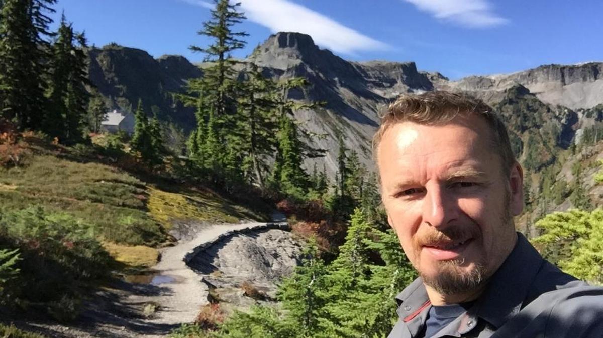 Bellingham ecologist and bear expert Chris Morgan appears in and narrates a new film short called “Wanted: Grizzly Bears?” It’s being released as federal agencies consider restoring a self-sustaining grizzly bear population to the U.S. side of the North Cascades, where they are nearing extinction. Here he is standing in front of Table Mountain.