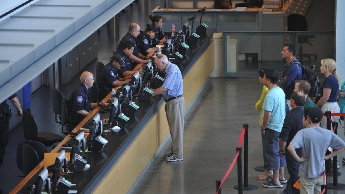 U.S. Customs and Border Protection officers interview travelers heading into the United States at the Peace Arch border crossing in Blaine, Sept 8, 2011.
