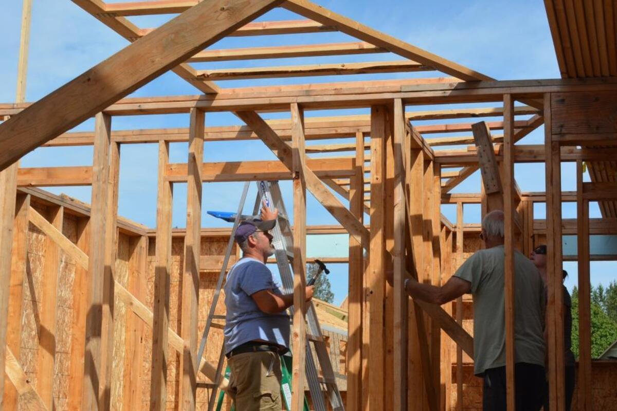 Nate Ashby works on a home that will belong to one of his neighbors in the Drayton Reach development.
