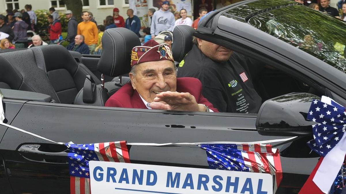 World War II pilot Joe Moser waves to the crowd during the Blossomtime Parade in Bellingham on May 23, 2015. He was the parade’s grand marshal.