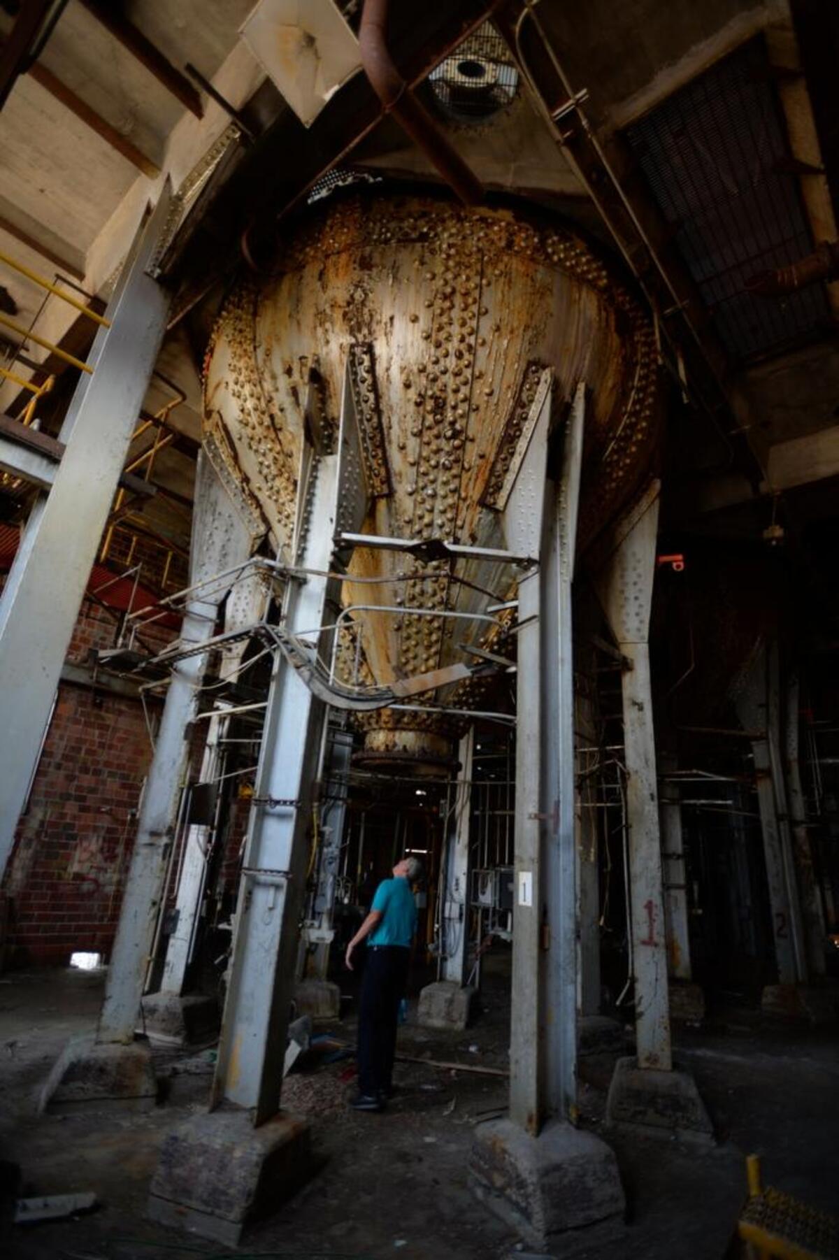 Port spokesman Mike Hogan stares up a digester tank inside the digester plant at the old Georgia Pacific waterfront, in Bellingham, Aug. 13, 2015.