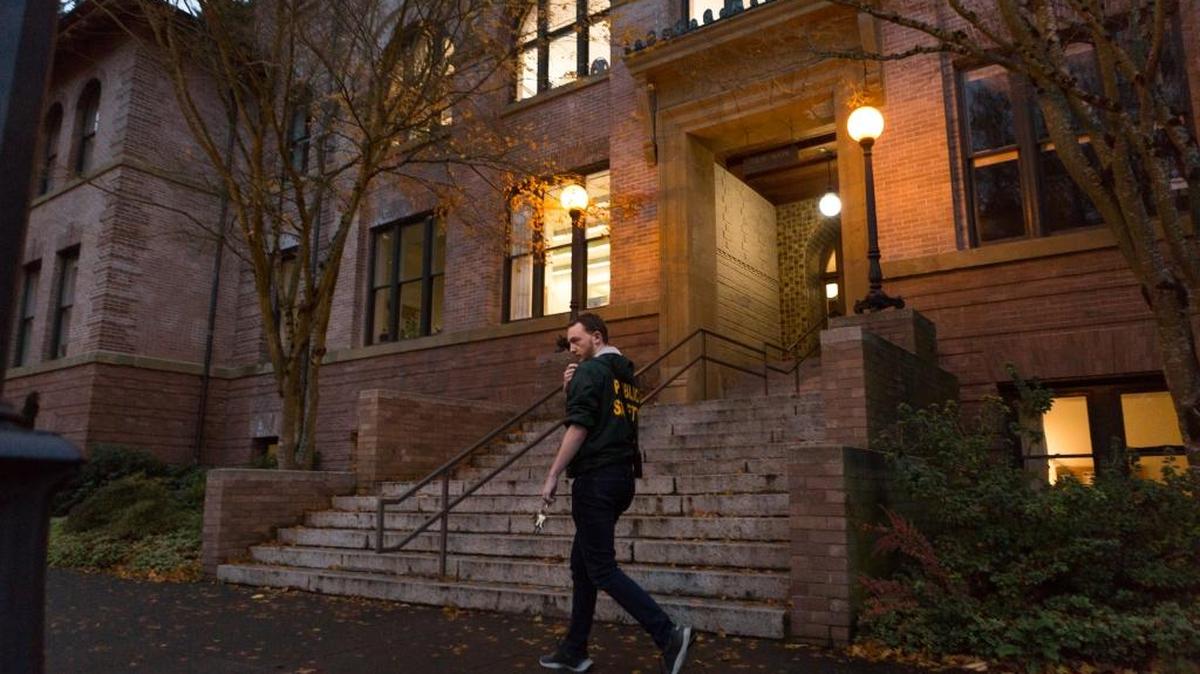 Sean Highley, a Western Washington University sophomore who works as a “Green Coat” safety escort, is shown on campus last week.