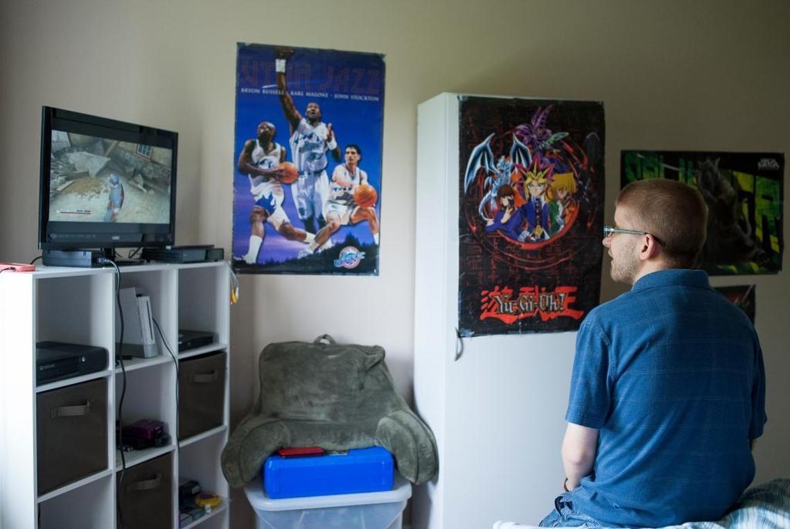 Ricky Manwill, 27, plays a video game in his room at Pine Street Home on Wednesday, May 10, in Lynden. Pine Street is a home operated by Cascade Connections for adults with developmental disabilities.