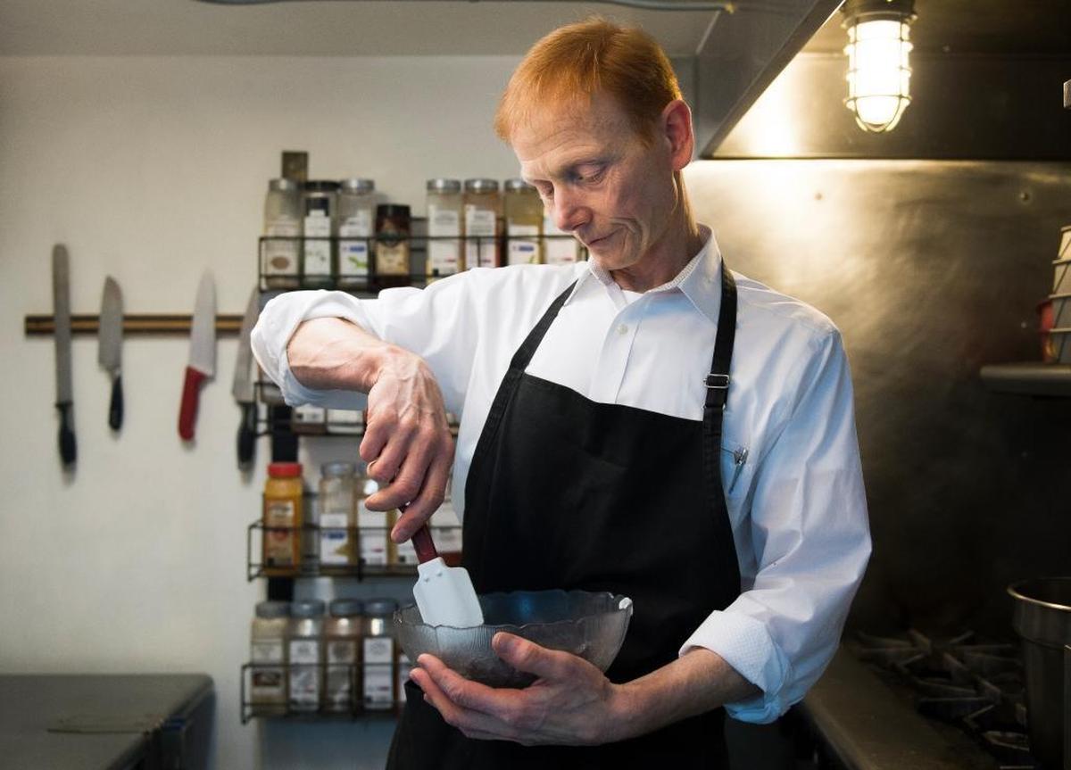 Don White, owner of Skylark’s Hidden Cafe, makes raspberry-infused chocolate mousse on Thursday, Feb. 15, in Bellingham. White plans to sell the restaurant and move to New York City.