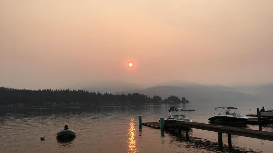 Smoky skies from wildfires in central British Columbia turned the rising sun into an orange ball over Lake Whatcom the morning of Wednesday, Aug. 2, 2017.