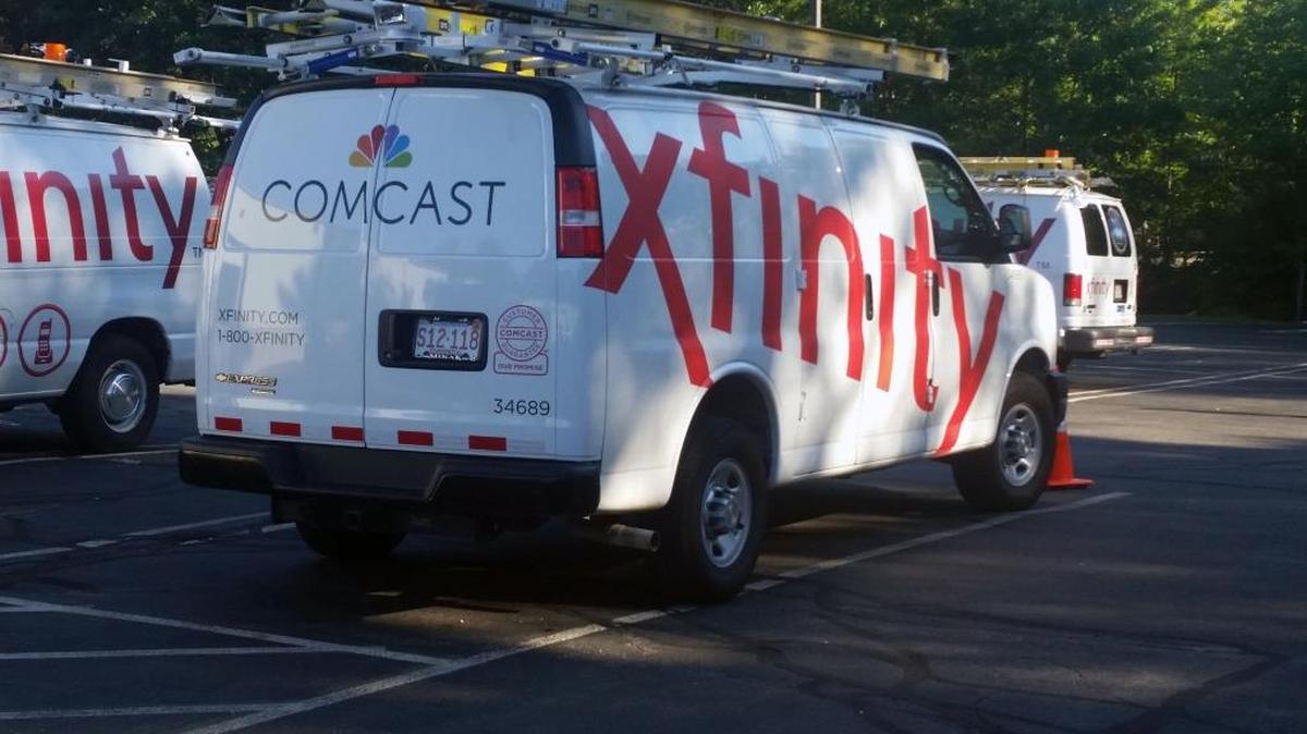 In this Sept. 17, 2015 photo, Comcast trucks are parked in a lot in the company’s Westford, Mass. operations center. Whatcom County let its franchise fee agreement with Comcast lapse and will renegotiate it.