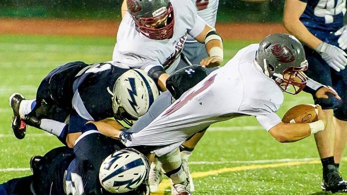 Squalicum’s Brian Pullman (22) and Will Nickleson (32) tackle WF West’s Elijah Johnson (3) at the line of scrimmage during the third quarter in the first round of the Class 2A State Playoffs Saturday, Nov. 14, at Civic Stadium. Squalicum defeated WF West 31-29.