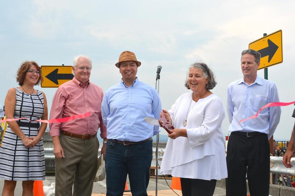 Bellingham Mayor Kelli Linville cuts a ribbon in celebration of the start of major cleanup work along downtown’s contaminated waterfront on Wednesday, Aug. 12. 