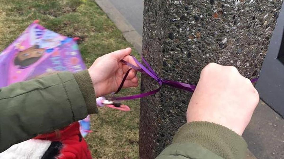 Children tie violet-colored ribbons in memory of Vylit Vander Giessen on trees near Scenic and Mercedes drives in Lynden on Monday, March 13, 2017.