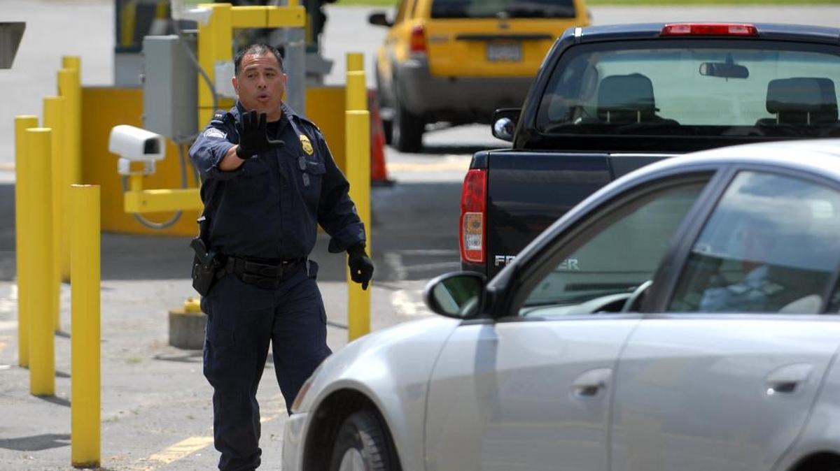 
U.S. Customs and Border Protection officer Edward Escobar directs traffic into the U.S. at the Lynden border crossing in 2009. Canadian traffic coming across the border in Whatcom County has fallen dramatically as the loonie has tumbled in value compared to the U.S. dollar.
