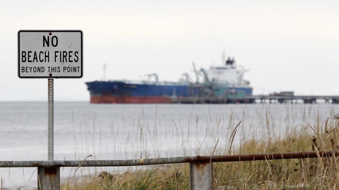 In this Oct. 23, 2012, file photo, a ship is moored at a BP oil refinery in the Strait of Georgia just beyond the location of a proposed coal exporting terminal in Ferndale.