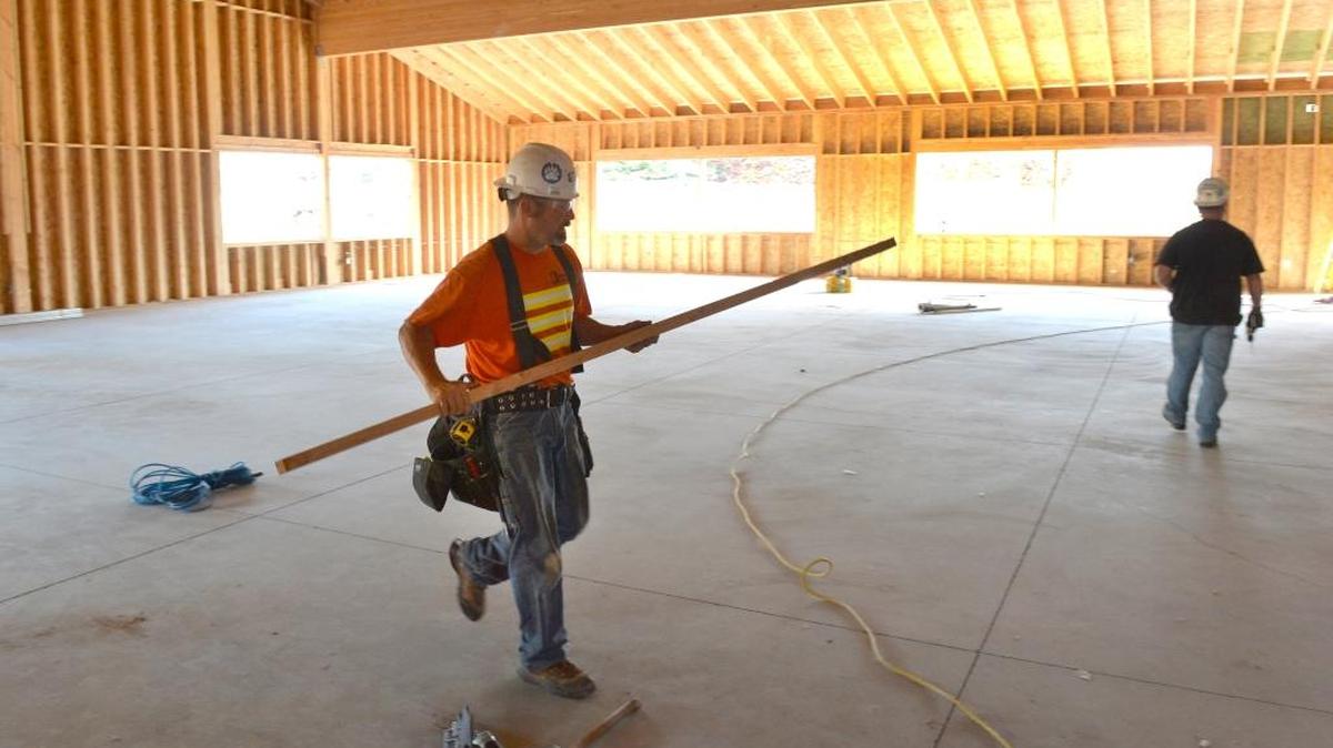 
Colacurcio Brother Construction’s Tim Wolf, left, and Scott Electric’s Randy Gray work inside the new Pavilion at the Blaine Community Center under construction Thursday, Aug. 27, 2015.
