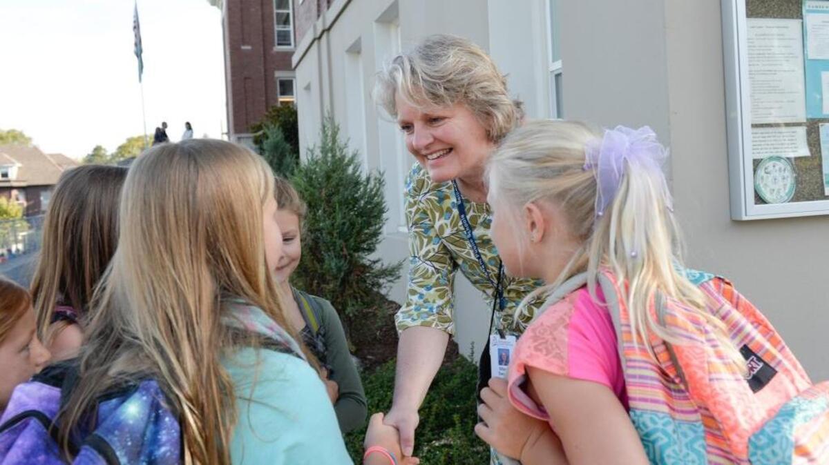 
New principal Mary Sepler greets students arriving for the first day of school at Lowell Elementary School on Wednesday, Aug. 26, 2015.
