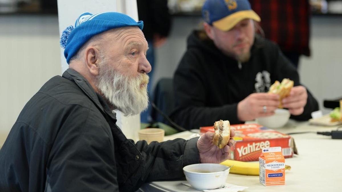 Bruce Dixon, left, and Mike Wise eat lunch at Lighthouse Mission Ministries’ Drop-In Center on West Holly Street in Bellingham on Wednesday, March 1, 2017. The center has been operating as a temporary 24/7 “easy-access shelter” since October.