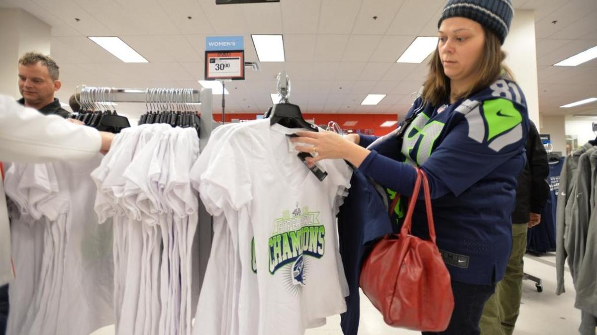 Jodene Oberlander of Bellingham picks out commemorative Seattle Seahawks Super Bowl shirts for her family at the Sports Authority at Bellis Fair mall Feb. 3, 2014. Sports Authority will close all 450 stores, including the one in Bellingham, after going bankrupt.
