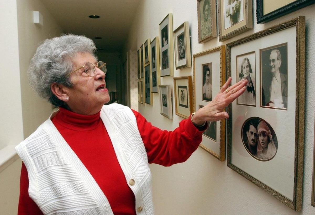 Showed in March 2004, Noemi Ban, who survived the Holocaust, looked at family photographs in a hallway in her Bellingham home. Unfortunately, many of those framed faces did not survive the horrors of Auschwitz.