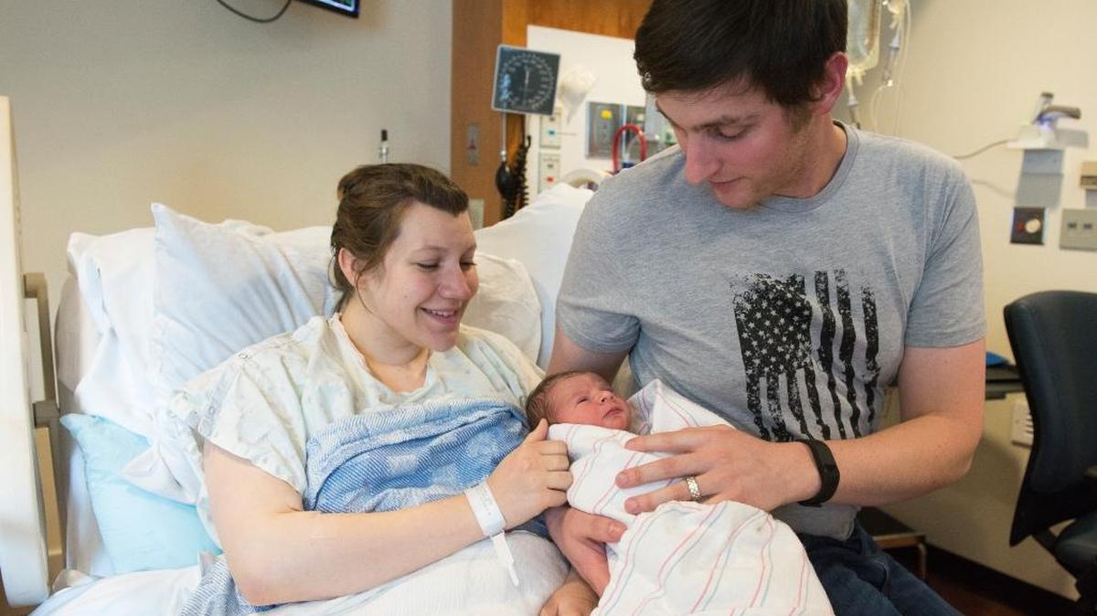 Addie Scott, left, and Ryan Scott, right, hold their newborn son Slater Scott on Sunday, Jan. 1, 2017 in Bellingham. Slater was due on Christmas Day but held off for a week, making him the first baby born of the new year at PeaceHealth St. Joseph Medical Center.