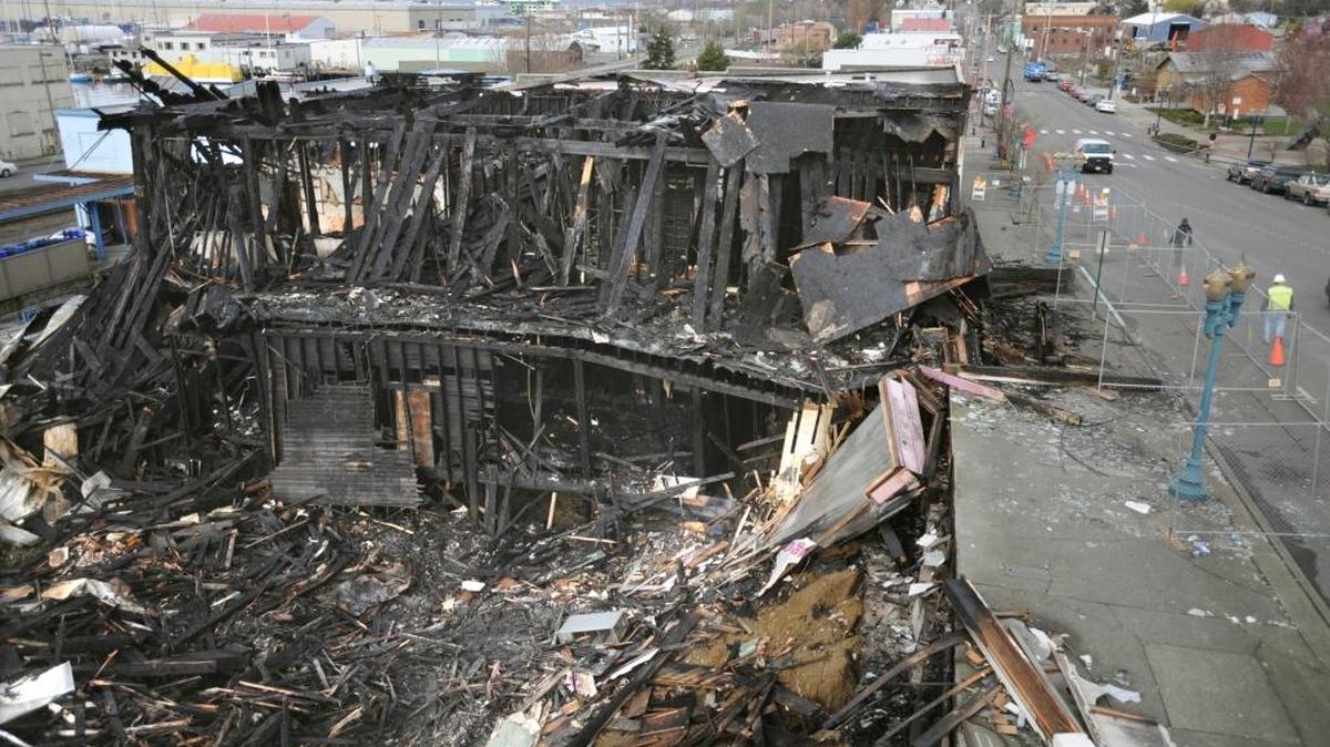 The remains of the three Old Town buildings smolder after being destroyed by fire early Monday, March 1, 2010 in the 400 block of West Holly Street of Bellingham. In 1885, when a cluster of buildings in the same district caught fire, men sped into saloons and the Washington Hotel to rescue the local liquor supply.